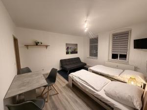 a living room with two beds and a couch at Apartment DENISA in Gera