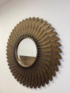a mirror on a wall with a metal frame at Cozy Beachside Studio with Beach Access & Pool in Marigot +14 photos