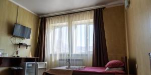 a bedroom with a window and a bed with pink sheets at Turgen Resort in Taūtürgen