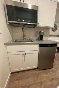 a kitchen with a sink and a microwave at Home at Kingwood in Forest Grove in Forest Grove
