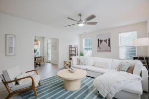 a living room with a white couch and a table at Happy in Old Town Bluffton in Bluffton