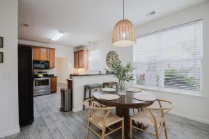 a kitchen and dining room with a table and chairs at Happy in Old Town Bluffton in Bluffton