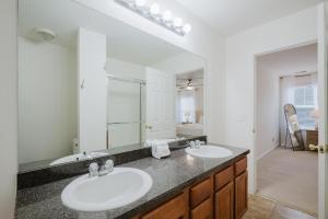 a bathroom with two sinks and a large mirror at Happy in Old Town Bluffton in Bluffton +37 photos