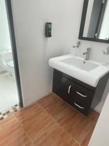 a bathroom with a sink and a mirror at Hotel Casa Bendicion in Los Limones +55 photos