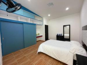 a bedroom with a large bed and a blue door at Hotel Casa Bendicion in Los Limones