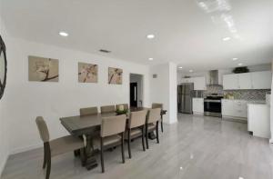 a dining room and kitchen with a table and chairs at Spacious 3BR Oasis Pool Fire Pit & Family Fun in Cowley