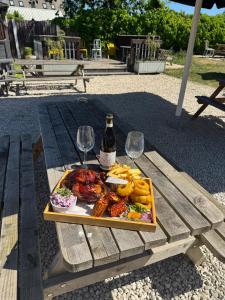 a tray of food and wine glasses on a picnic table at The Red lion in Gloucestershire