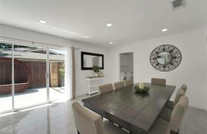 a dining room with a wooden table and chairs at Spacious 3BR Oasis Pool Fire Pit & Family Fun in Cowley +14 photos