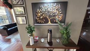 a wooden table with flowers on it in a living room at Hotel Dourado in Alfenas +17 photos
