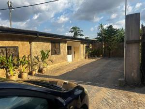 a car parked in front of a building at One Bedroom Studio Apartment in Benin City