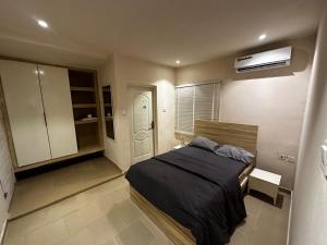 a bedroom with a bed and a air conditioner at One Bedroom Studio Apartment in Benin City