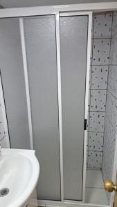 a bathroom with a sink and a shower and a toilet at Cabaña recinto Super vista, WIFI con terraza4 in San Antonio