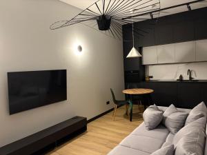 a living room with a couch and a table at Apartamenty Arkady in Police