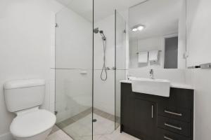 a bathroom with a toilet and a sink and a shower at Quest Dandenong in Dandenong