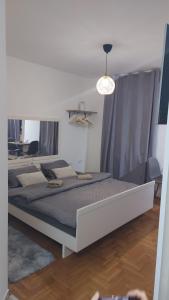 a bedroom with two beds and a pendant light at River stay in Sremska Mitrovica