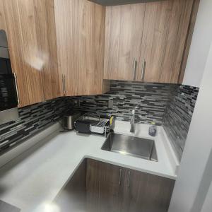 a kitchen with a sink and a microwave at beautiful private house in Edmonton +43 photos