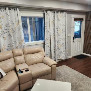 a living room with a couch and a window at beautiful private house in Edmonton