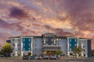 a rendering of a hotel with cars parked in a parking lot at Best Western Plus Laredo Inn & Suites in Laredo