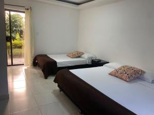 Ένα ή περισσότερα κρεβάτια σε δωμάτιο στο Hotel Campestre Nogal de Cafetal +51 φωτογραφίες