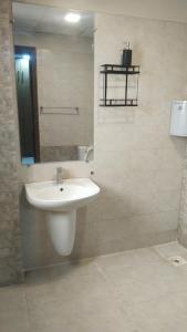 a bathroom with a white sink and a mirror at Afzal real estate builder's in Islamabad +2 photos