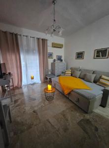 a bedroom with a large bed and a couch at Aghia Marina, Aegina Studio in Aegina Town