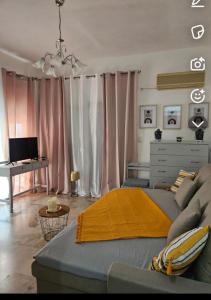 a bedroom with a bed and a desk in a room at Aghia Marina, Aegina Studio in Aegina Town +6 photos