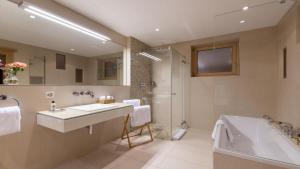 a bathroom with a sink and a tub and a shower at Entrebin PremiumChalet AO in Aosta +17 photos