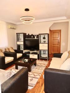 a living room with couches and a tv at Chez Apartment in Prizren