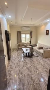 a large living room with a couch and a table at نزل الصيف للشقق المخدومة in Al Namas