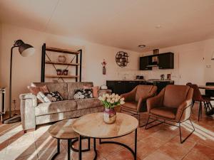 a living room with a couch and a table at Apartment in Uitgeest by the Waterpark in Uitgeest