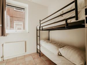 a bedroom with a bunk bed and a window at Apartment in Uitgeest by the Waterpark in Uitgeest
