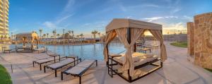 a resort with a pool with chaise lounges and avisorvisorvisor at Las Palomas OV 4BR 4BA Cortez 901 in Puerto Peñasco