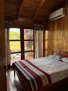 a bedroom with a bed and a large window at Luz de campo in Dos de Mayo +27 photos