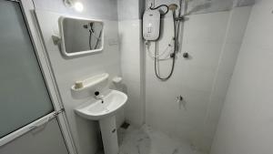 a white bathroom with a shower and a sink at Green Wall House in Dickwella +43 photos