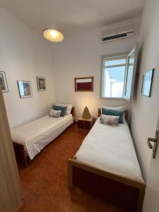 a room with two beds and a window at villa De Simone in Campomarino