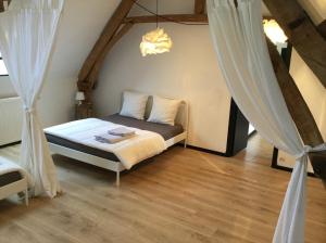 a bedroom with a bed and curtains in a room at Le Big Family - LE MONT DE LA LOUVE in Bazinghen