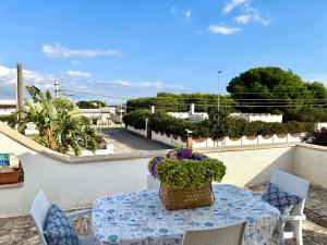 a table with a basket of flowers on a balcony at villa De Simone in Campomarino