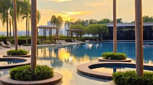 a pool at a resort with palm trees at Trion Sky Suite KL in Kuala Lumpur
