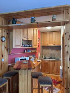 a kitchen with wooden cabinets and a table and chairs at Apartman Savic Jahorina in Jahorina