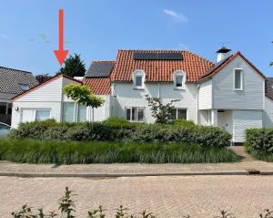 a white house with a red roof at 'het Haasje' in Hedel