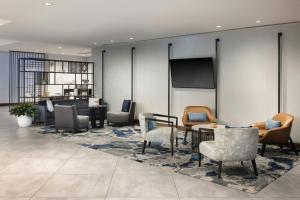 a lobby with chairs and tables and a projection screen at Atlanta Marriott Perimeter Center in Atlanta +47 photos