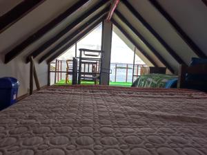 a bedroom with a bed and a chair in a tent at Ecolodge Aymara in Comunidad Challapampa