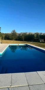 una gran piscina azul en la parte lateral de una casa en Lara cabañas, en Guaymallén
