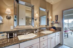 a bathroom with two sinks and two mirrors at Stunning Oceanview Townhouse Walk to Seawall, Shops & Depoe Bay Dining in Depoe Bay +49 photos
