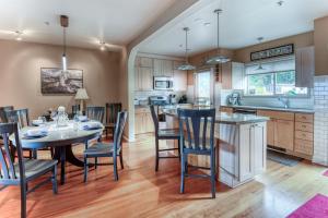 a kitchen and dining room with a table and chairs at Stunning Oceanview Townhouse Walk to Seawall, Shops & Depoe Bay Dining in Depoe Bay
