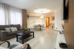 a living room with a couch and a table at Porto Panorama by Sira Stays in Porto
