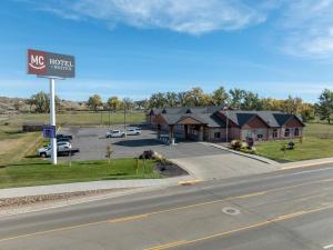 a sign for a hotel on the side of a road at Miles City Hotel & Suites in Miles City