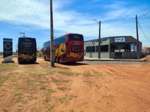 two buses parked on the side of a dirt road at Carolina Palace HOTEL in Carolina +10 photos