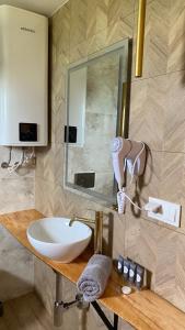 a bathroom with a sink and a mirror at Osada Międzywodzie in Międzywodzie
