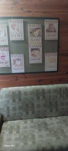 a headboard of a bed with posters on a wall at recanto de pepe 1 in Santa Vitória do Palmar